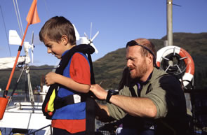 A student is helped into a lifejacket before boarding Silurian for an educational visit